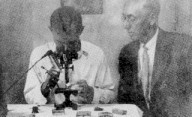Dr. Lloyd Watson instructs Jay Alfred in artificial insemination